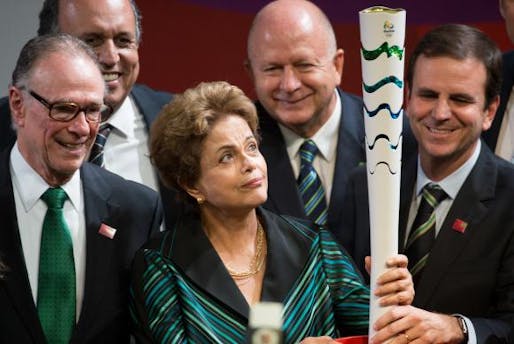 President Dilma Rousseff holding the Olympic torch, accompanied by the president of BOC Carlos Arthur Nuzman (left), and the Mayor of Rio de Janeiro, Eduardo Paes (right). Photo: Wikipedia.
