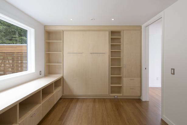 Two offices are outfitted with semi-custom built-ins that include murphy wall beds.