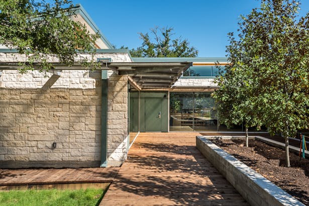 The existing building (not pictured) adjacent to this one is a Texas Hill Country-styled former daycare center. It has a hipped roof and limestone walls. The intention is for that building to remain an integral part of the campus.