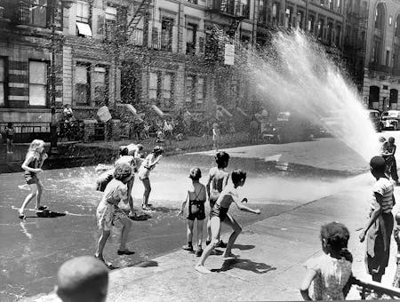 New York, New York. Children escape the heat of the East Side by using fire hydrant as a shower bath in 1943. Photography by Roger Smith. Image courtesy of Library of Congress 