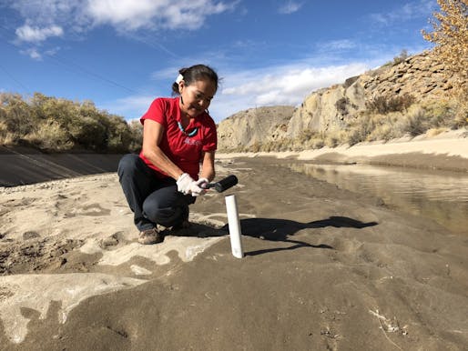 Karletta Chief, an associate professor and Extension specialist in the UArizona Department of Environmental Science and the new center's director, pounds a soil sample tube into the Hogback irrigation canal near Waterflow, New Mexico, on the Navajo Nation in 2017. Image: The University of Arizona/Courtesy of Karletta Chief