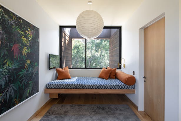 Photography by Taiyo Watanabe. The 'Perch,' with a custom Eucalyptus built-in daybed tucked between bedrooms, allows for a unique and quiet spot perfect for meditation, lounging, and gazing into the trees.