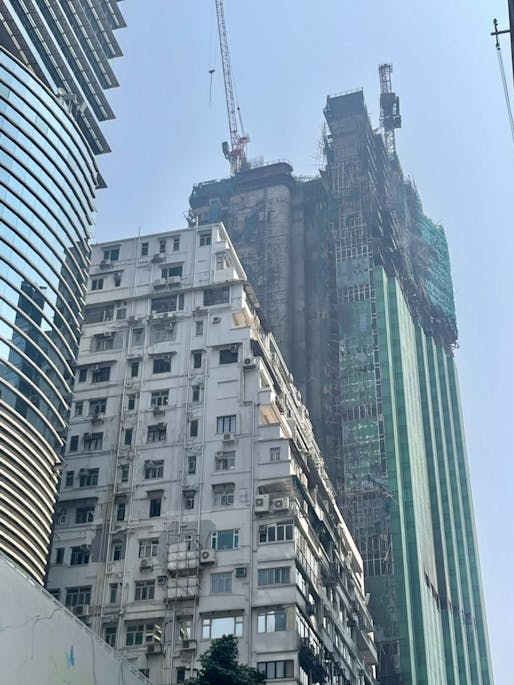 Aftermath from Thursday evening's tower blaze in the Hong Kong neighborhood of Tsim Sha Tsui. Image via Joyce Zhou <a href="https://twitter.com/XuhanJoyceZhou/status/1631511364069113856">@XuhanJoyceZhou via Twitter.</a>
