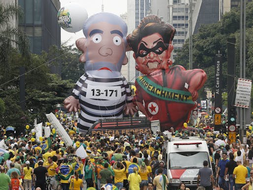 Demonstrators parade large inflatable dolls, depicting Brazil's former President Luiz Inacio Lula da Silva in prison garb and current President Dilma Rousseff dressed as a thief, in Sao Paulo on Sunday. Image by Andre Penner/AP via npr.org.