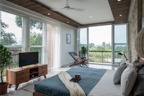 master bedroom: Locally sourced sand stone and wood have been developed and used on the walls, offering warmth to each area, giving it a contemporary yet rustic feel.