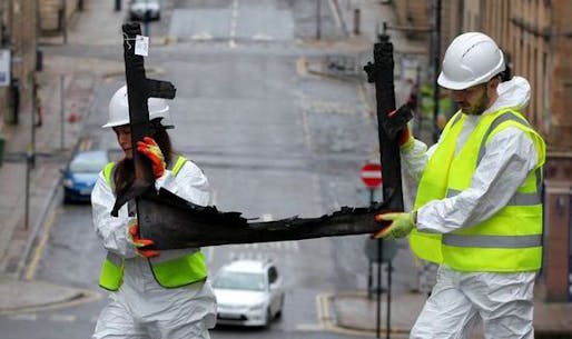 Workers remove charred remnants of the Art School from the scarred building (Scottish Express; Photo: HEMEDIA)