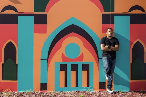 Architect/artist/city planner Germane Barnes in front of the Opa-Locka Community Development Corporation's Arts & Recreation Center. Mural by Lekan Jeyifo. Photo: Matthew Roy, via Curbed.