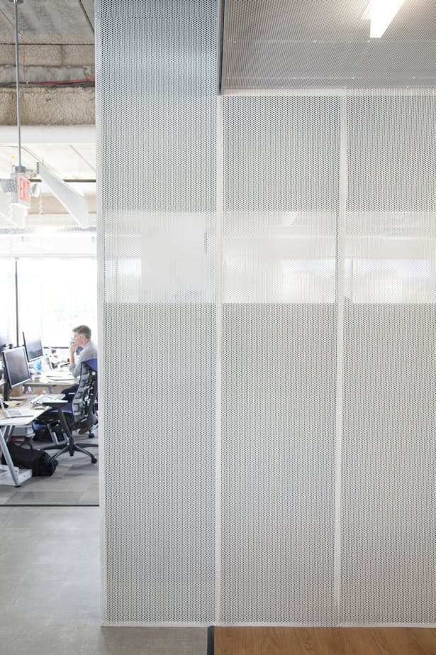 'Soft' conference room walls are built with perforated metal mesh embedded with acoustic cellulose panels for sound absorption.