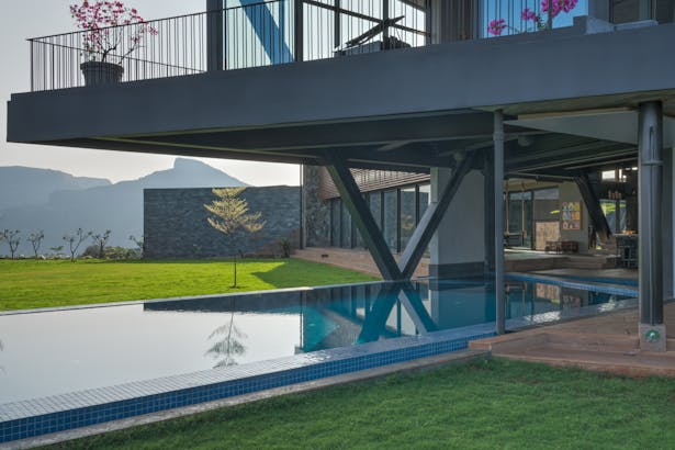 The metal structure cantilevers over the pool making it usable in all climates