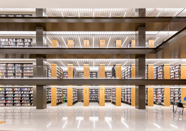 Book stacks are a vertical means of storing books dating back to the nineteenth century, and here they are revived to give open access for library users. Image copyright by Max Touhey