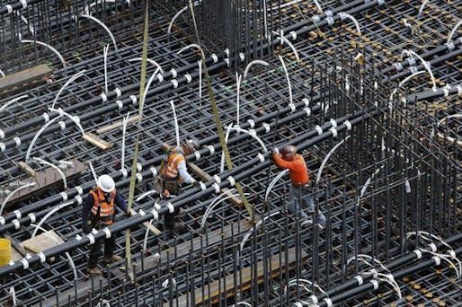 Workers position pipes in the 18-foot-deep pit that will be filled with concrete to form the foundation for the New Wilshire Grand skyscraper at 7th, Wilshire and Figueroa. For the tallest structure to be built west of the Mississippi, the concrete will be poured without interruption. (Mel Melcon / Los Angeles Times / February 7, 2014)