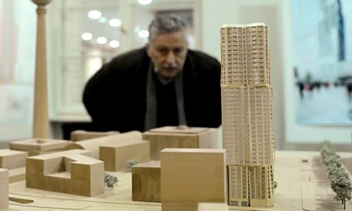 A journalist looks at the model of the Hines tower, right, the construction of which is expected to start in 2015. (The Guardian; Photograph: Britta Pedersen/Corbis)