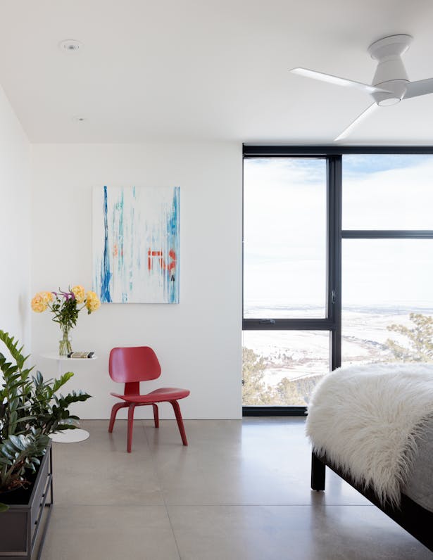 Floor-to-ceiling windows keep the focus on the landscape while making the secondary rooms feel larger and connected to nature.