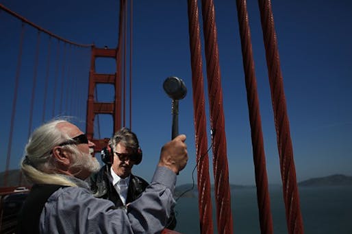 Doug McKechnie (left) and Paul de Benedictis of the S.F. Synthesizer Ensemble record the tones produced by striking different parts of the Golden Gate Bridge with a rubber mallet earlier this month. 