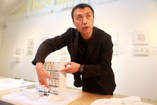 Li Hu displays a model of the Deep Ocean Research Base, one of Open Architecture's projects, at Studio-X Beijing. Feng Yongbin / China Daily