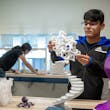 A student in the Fab Lab holds a 3-D printed object. Image courtesy of NYIT School of Architecture and Design