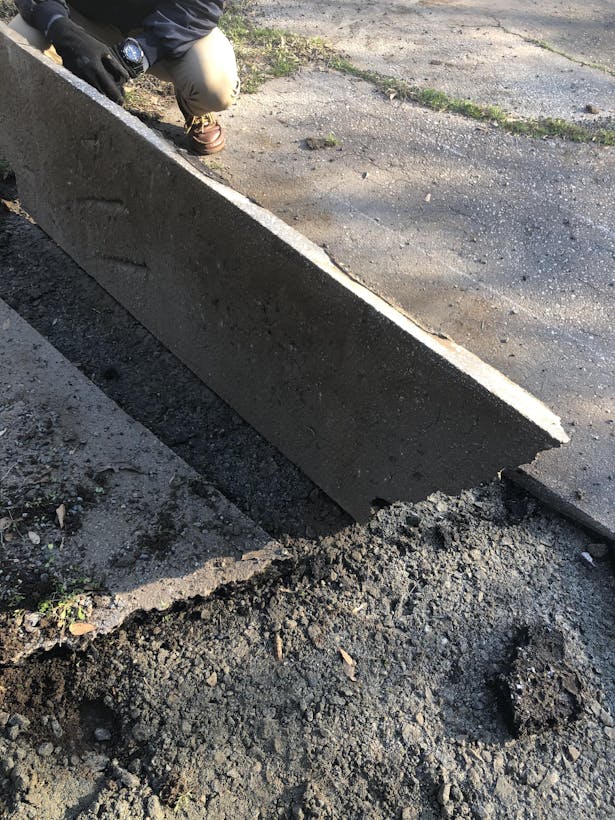 With the utilization of a walk-behind concrete saw, chalk and string, and surveying equipment we were able to create a grid system relative to a known point and measure out 'bricks' from the existing parking lot for use as a rock wall.