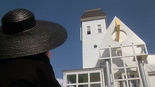 The film's character Lydia Deetz stands in front of the newly-remodeled home purchased by her family in the 1988 Tim Burton movie, Beetlejuice. Image still courtesy of flim.ai.