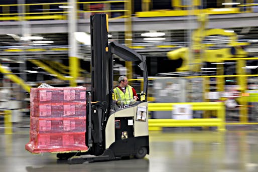 Forklift opperator moving pallets of goods; Image courtesy of Ted S. Warren/AP