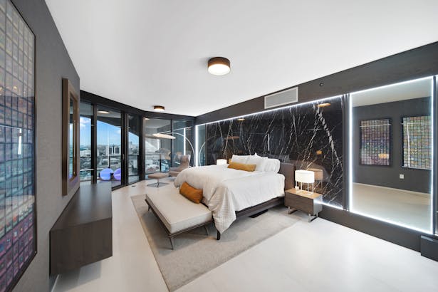 Master bedroom custom wenge and nero marquina LED-lit headwall photo by Robert Packar