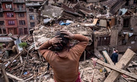 A resident surveys the result of a 7.8 magnitude earthquake in Nepal (courtesy David Ramos/Getty Images).