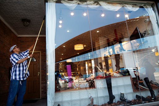 George Aiken, 55, washes the windows of a store on Flatbush Avenue. Credit- Victor J. Blue for The New York Times 