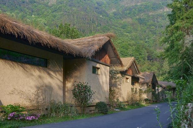 imitated rammed earth thatched cottage