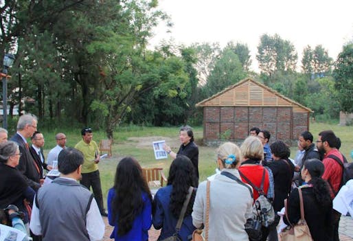 The photo shows Shigeru Ban presenting a Nepal House Project prototype in Kathmandu after the devastating 2015 Nepal earthquake. (Photo courtesy of VAN - Voluntary Architects' Network)