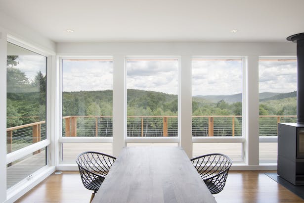 Open living, dining, kitchen space gets panoramic views for a relatively modest home.