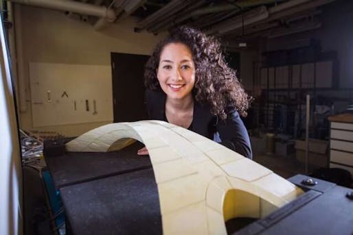 "Masters of engineering student Karly Bast shows off the scale model of a bridge designed by Leonardo da Vinci that she and her co-workers used to prove the design’s feasibility." Credit: Gretchen Ertl (Courtesy of MIT)
