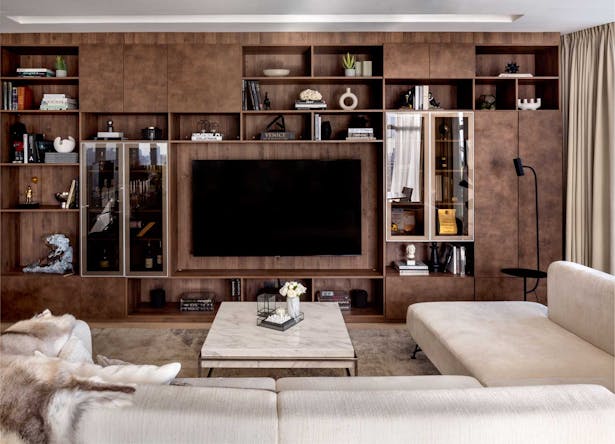 Full wall entertainment center featuring a deep and dark tone of wood 