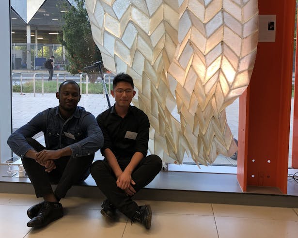 Landscape architecture alums Jimi Demi-Ajayi and Julian Huang in front of the “Phototropic Origami Fiber Composite Structure" in London.
