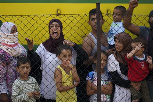 Women and children trying to escape from the conflict in Syria stand at a train station in Budapest. Credit: Wikipedia