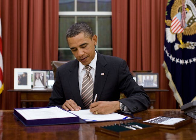 President Obama signing a bill, via wikimedia.org