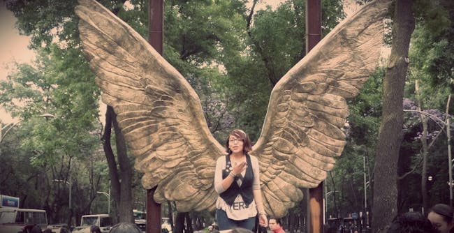an immense pair of bronze wings is a popular photo spot