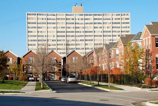 Old Town Village West townhomes, a new mixed-income development, ca. 2009; looming in the background is the William Green Homes high-rise, part of Cabrini-Green, demolished 2011. [Photo: Lawrence J. Vale]