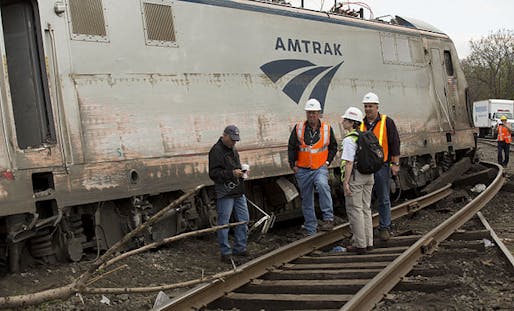 National Transportation Safety Board officials inspect the derailed Amtrak locomotive in Philadelphia. Photo via Wikipedia.