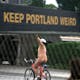 A nude cyclist rejoices in Portland's weirdness. Image via gomadnomad.com.