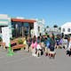 Sixth-grade students from the Watts Learning Center in Los Angeles line up to tour Crowder College and Drury University during the U.S. Department of Energy Solar Decathlon at the Orange County Great Park, Irvine, California, Friday, Oct. 9, 2015. (Credit: Thomas Kelsey/U.S. Department of Energy...