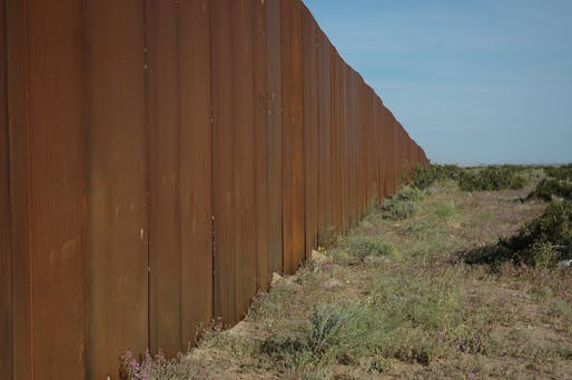 An existing segment of the US/Mexico border. Image via flickr.