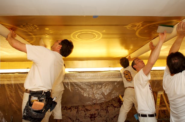 EverGreene Craftsmen installing the mural into the new ceiling