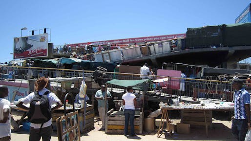 Informal workers conducting business outside of the metrorail station of Khayelitsha township, South Africa. (Image via Wikipedia)