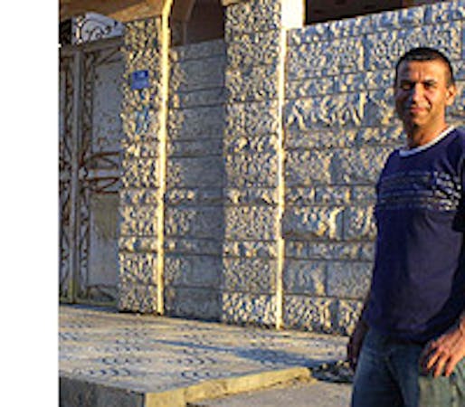Real estate broker Essam Mortja in front of a Gaza home. (Reese Erlich / Marketplace)