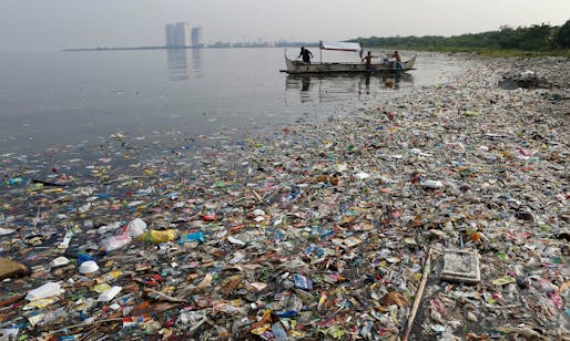 Fishermen float onboard a boat amid mostly plastic rubbish in Manila Bay, the Philippines. Humans have introduced 300m metric tonnes of plastic to the environment every year. Photograph: Erik de Castro/Reuters, via theguardian.com