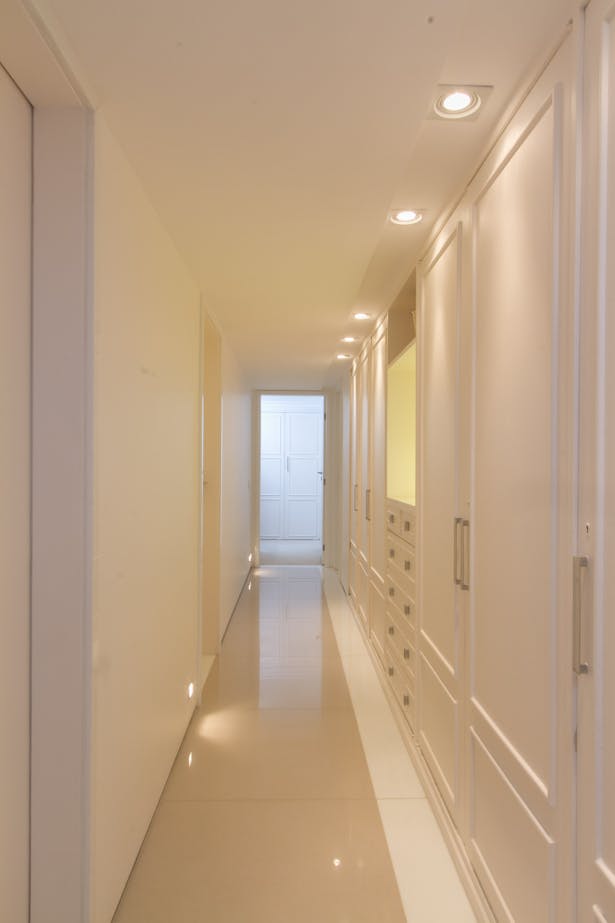 corridor towards bedrooms with restored recessed cabinets at right