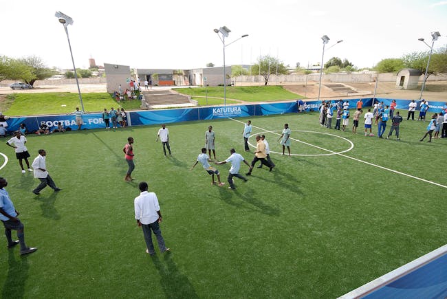 Playing on the pitch at the Katutura Football for Hope Center. Location: Windhoek, Namibia. Credit: Marcus Weiss
