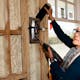 Bonnie Schnitta, an acoustical consultant, measures how much sound is coming through a wall outlet - Credit Daniel Gonzalez for The New York Times