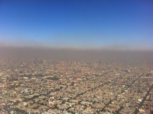 A layer of photochemical smog blankets Mexico City. Image via wikimedia.org